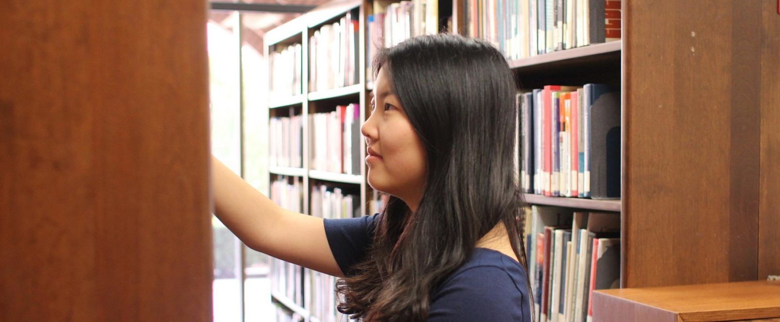 Gerontology student looking through library resources