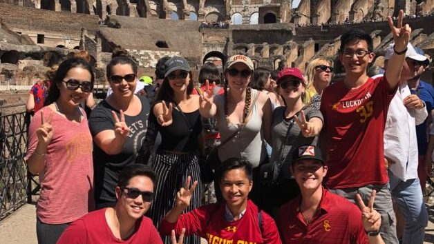 Students with peace signs at the Coloseum