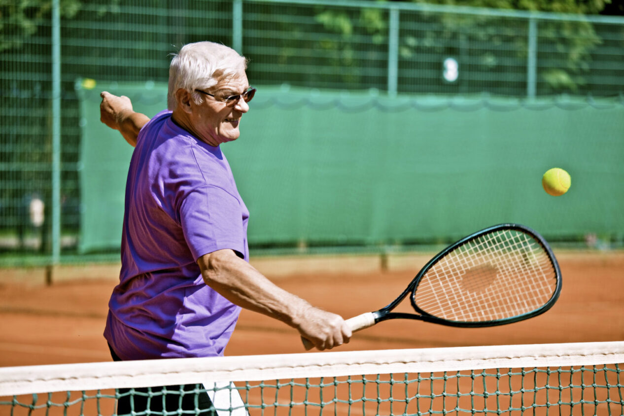 Senior playing tennis