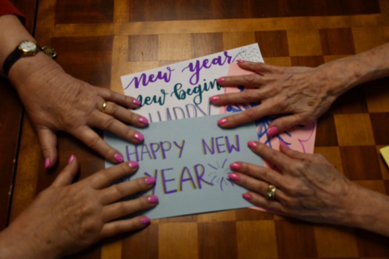 Cards and the hands of residents at Belmont Village