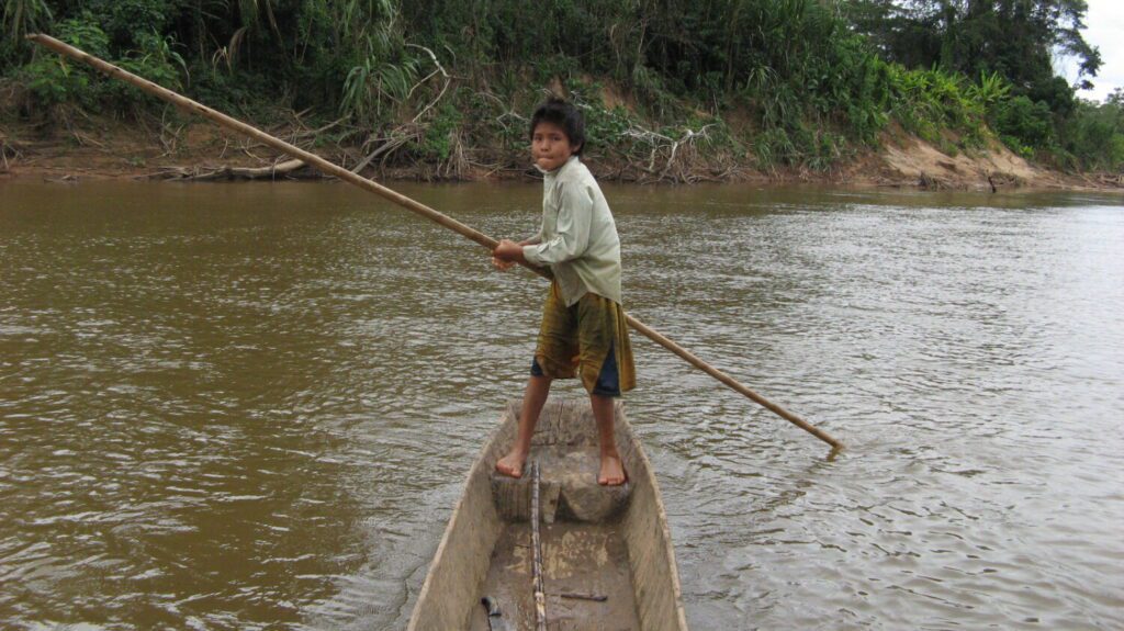 A young member of the Tsimane indigenous group in the Bolivian Amazon in a canoe (photo courtesy Tsimane Health and Life History Project Team)
