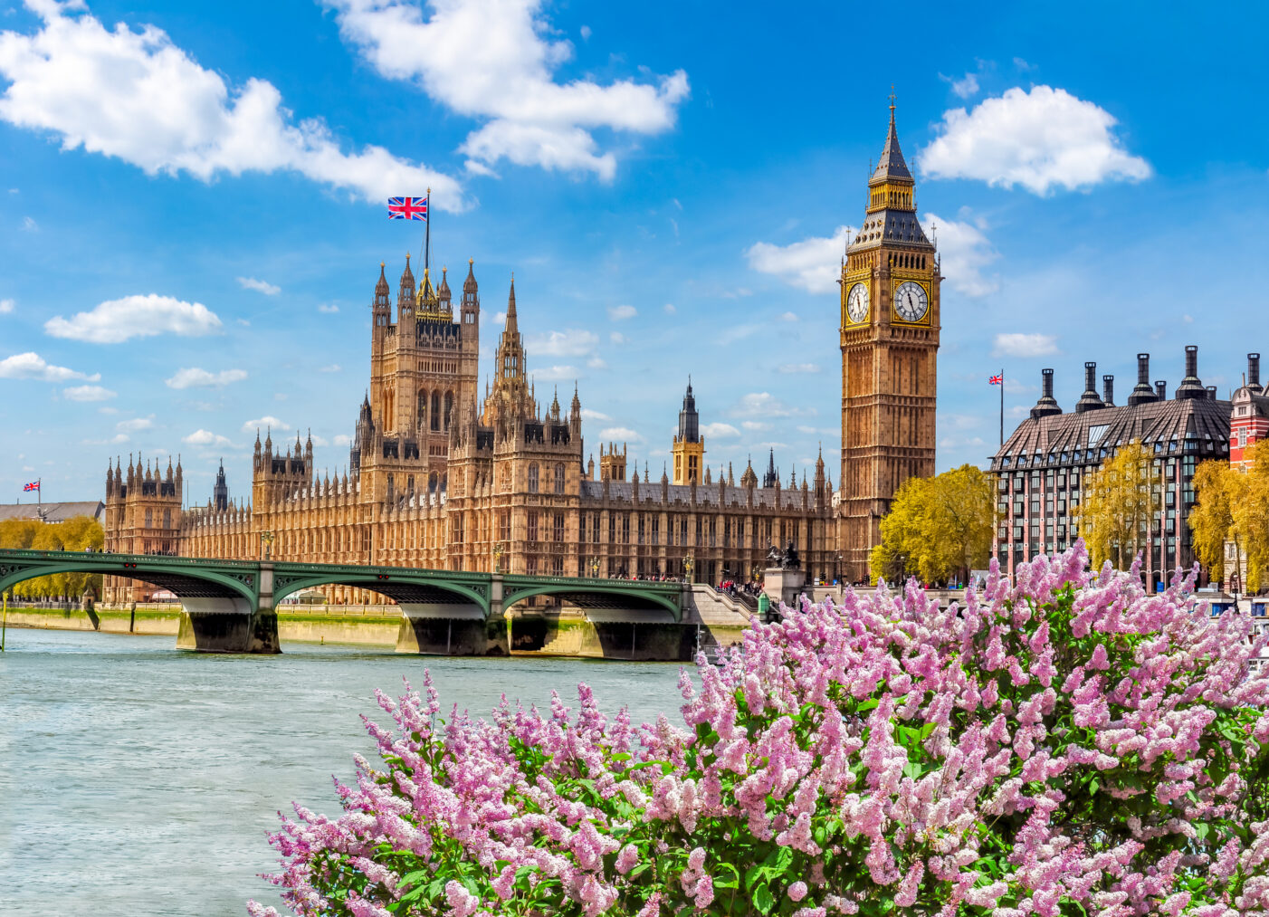 Scenic view of London, England featuring historic architecture and Big Ben under a blue sky