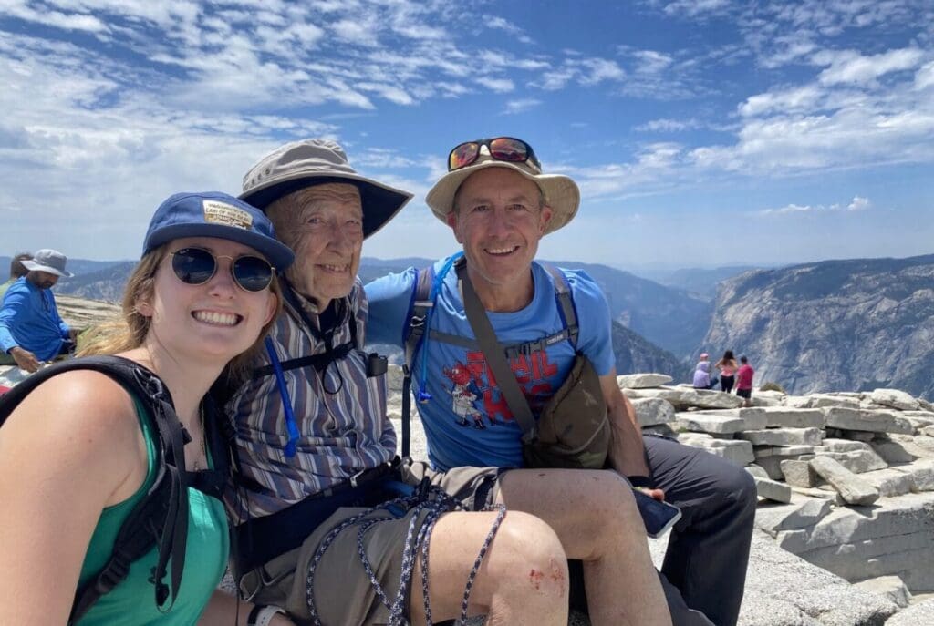 Portrait of Everett Kalin and family atop Half Dome in Yosemite National Park