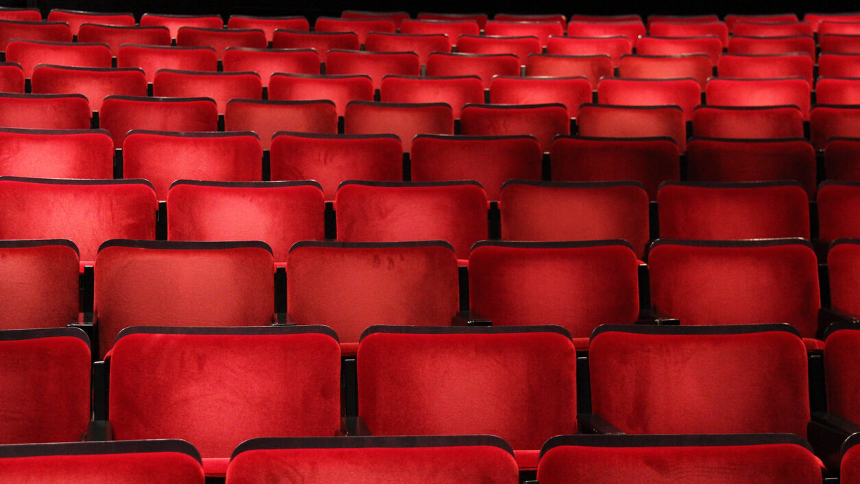 Rows of red chairs in an auditorium