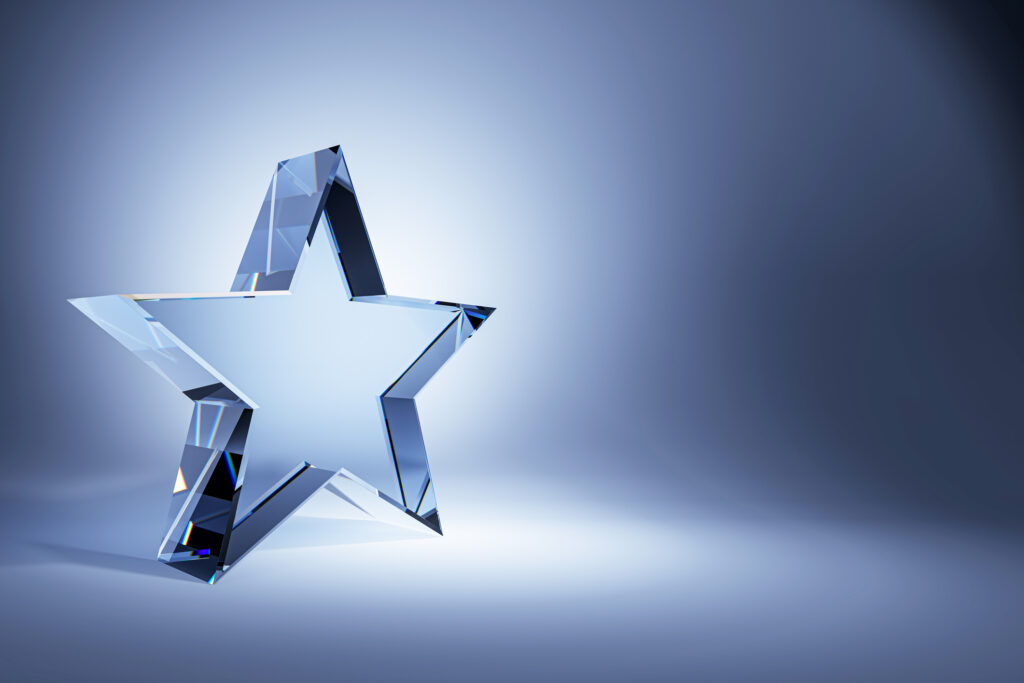 A crystal glass star trophy on a gradient blue background. The clean design and empty background make it perfect for award concepts. D Rendering.